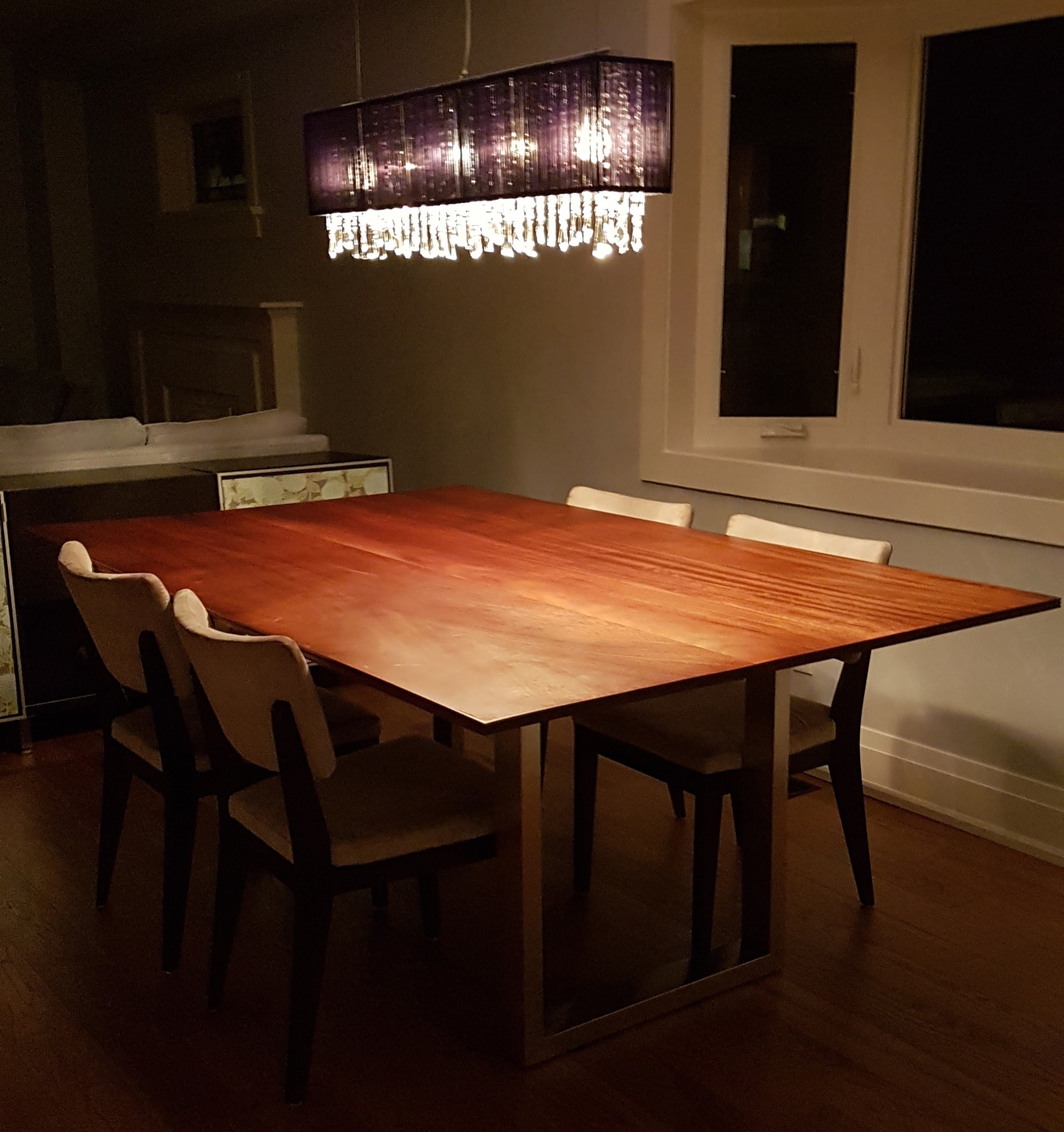 Custom-built mudroom with navy blue cabinetry and slatted wood wall